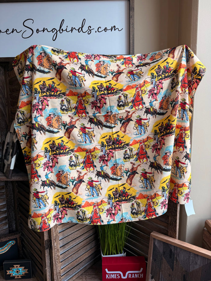 Western wild rag scarf with colorful cowboy scene pattern spread flat on display