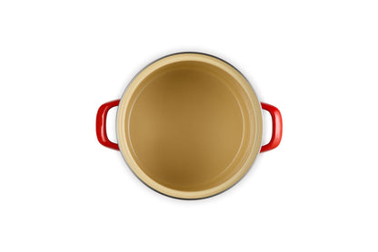 Beige inside stockpot with cerise handles on a white background
