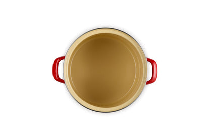 Beige inside stockpot with cerise handles on a white background