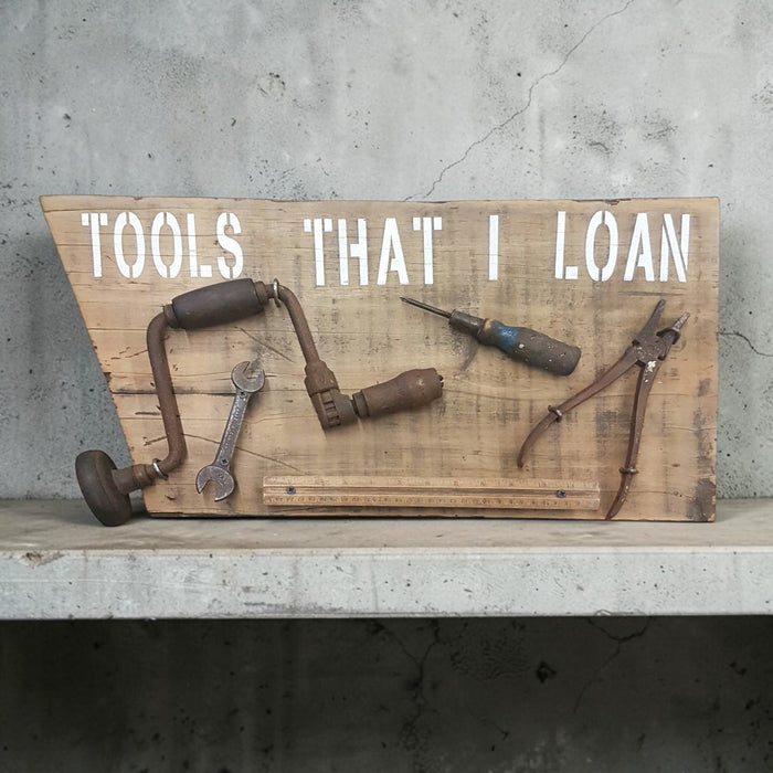 Handmade rustic Tools That I Loan garage sign with five useless tools